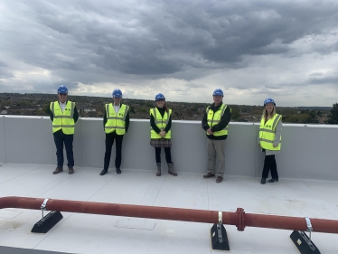 A photo of Councillor Potter on the roof of Leigh Academy